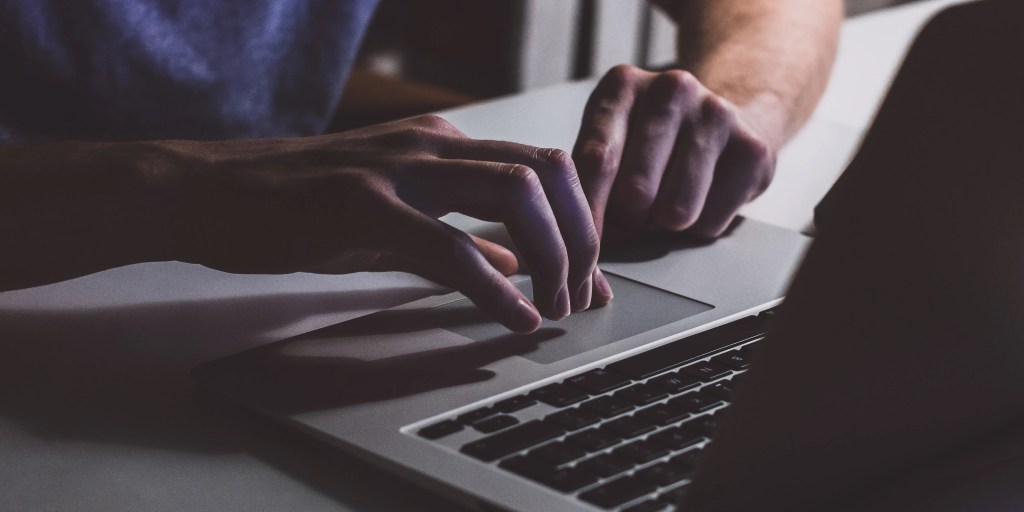 Hands using a laptop