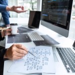 Man at laptop reviewing strategy