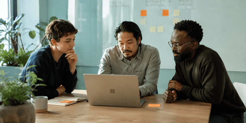Team reviewing documents on laptop