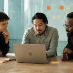 Team reviewing documents on laptop