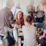 Team of young professionals working on project in office setting